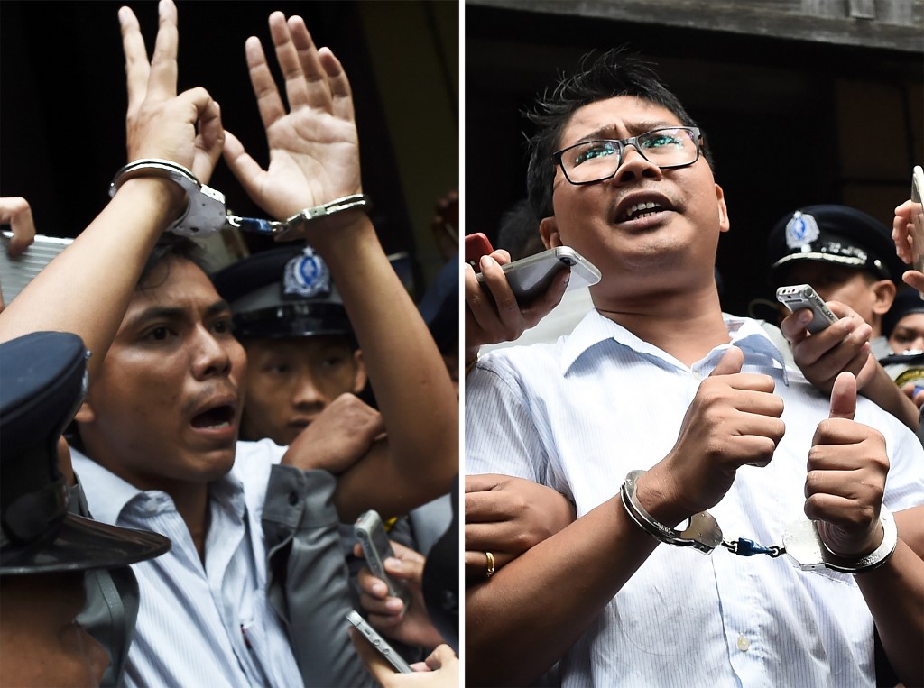(FILES) This file combination of photos taken on September 3, 2018 shows journalists Kyaw Soe Oo (L) and Wa Lone being escorted by police after their sentencing by a court to jail in Yangon. – Myanmar’s Supreme Court on April 23, 2019 rejected an appeal by two Reuters journalists jailed for seven years on charges linked to their reporting on the Rohingya crisis, a defence lawyer confirmed. Photo by Ye Aung Thu / AFP