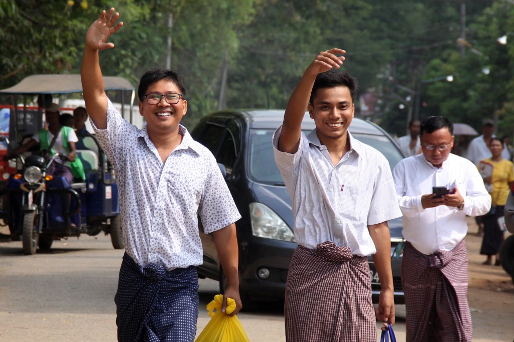 Reuters journalists Wa Lone  (L) and Kyaw Soe Oo gesture outside Insein prison after being freed in a presidential amnesty in Yangon on May 7, 2019. (Photo by – / AFP)