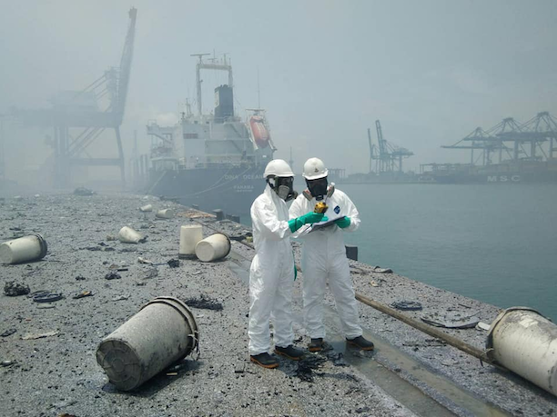 Pollution Control officials at the scene in Chonburi province after a ship-board fire triggered a blast, injuring 25. Photo courtesy Pollution Control Department
