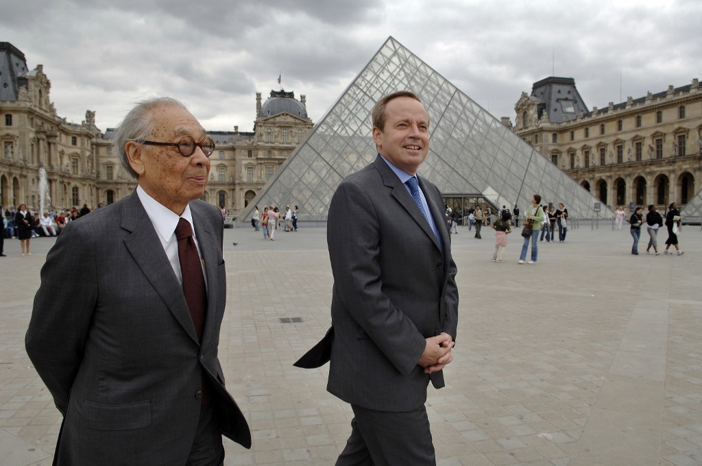 I. M. Pei (left) and French Culture Minister Renaud Donnedieu de Vabres walk past Pei’s iconic pyramid at the Louvre, in Paris. Photo via AFP.