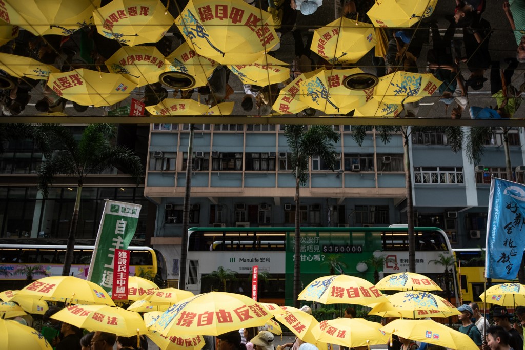 Pro-democracy activists attend a march in Hong Kong earlier this month to commemorate the June 4, 1989 Tiananmen Square crackdown in Beijing. Photo via AFP.
