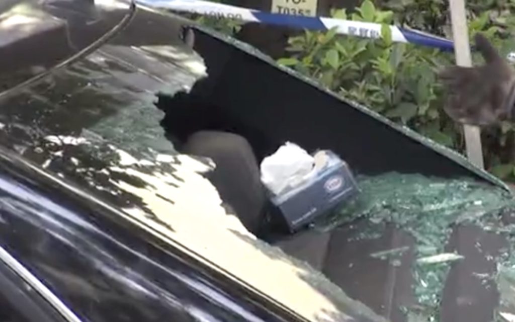 The back of a Mercedes Benz hours after an officer shot at it. Screengrab via Apple Daily video.