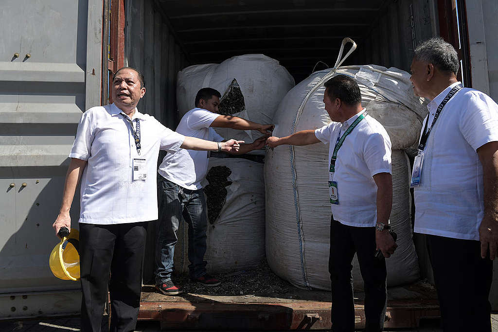 Bureau of Customs Port Collector John Simon opens a container van containing 22 sling bags of 2.561 tons of mixed electronic wastes before it will be sent back to Hong Kong at the Mindanao Container Port Terminal in Villanueva, Misamis Oriental. Photo: Froilan Gallardo/Greenpeace