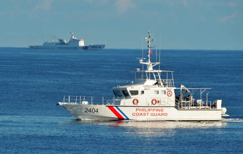 This photo taken on May 14, 2019, a Philippine coast guard ship (R) sails past a Chinese coastguard ship during an joint search and rescue exercise between Philippine and US coastguards near Scarborough shoal, in the South China Sea via Ted Aljibe/AFP
