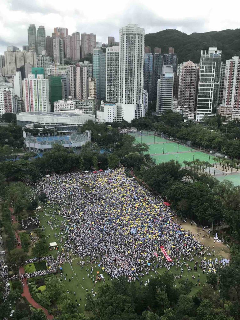 Protest-goers file into the staging area at Victoria Park ahead of today's enormous extradition bill demonstration. Photo by Chad Williams.