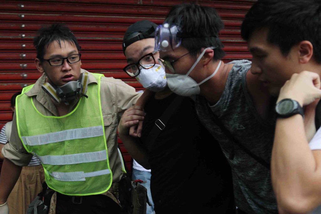 Protesters help a man who was hit with tear gas at a demonstration against a controversial extradition bill today. Photo by Samantha Mei Topp.