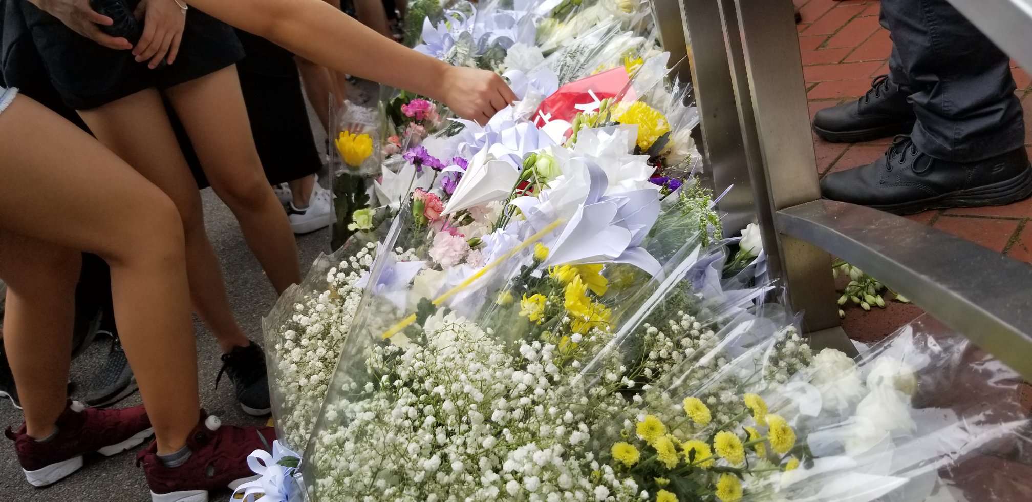 Hongkongers marching against controversial extradition law line up to leave thousands of flowers in honor of a protester who fell to his death on Saturday, June 15, at the Pacific Place mall. Photo by Vicky Wong/Coconuts Hong Kong