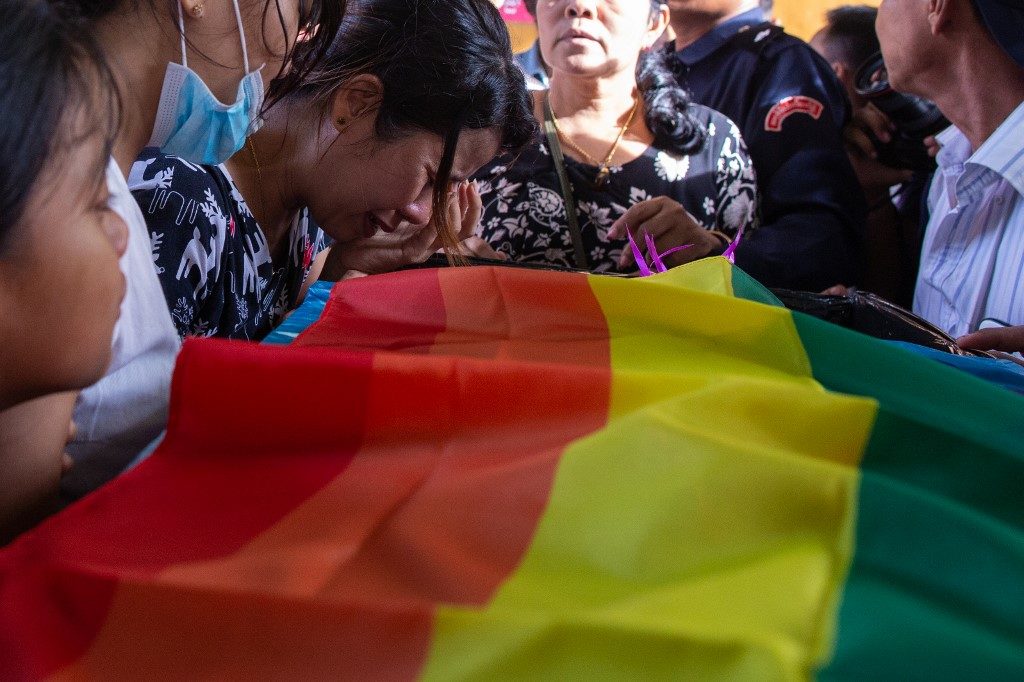 A relative cries over the coffin of Kyaw Zin Win, a gay man who took his own life after facing alleged homophobic bullying, during his funeral in Yangon on June 26, 2019. Photo by Sai Aung Main / AFP