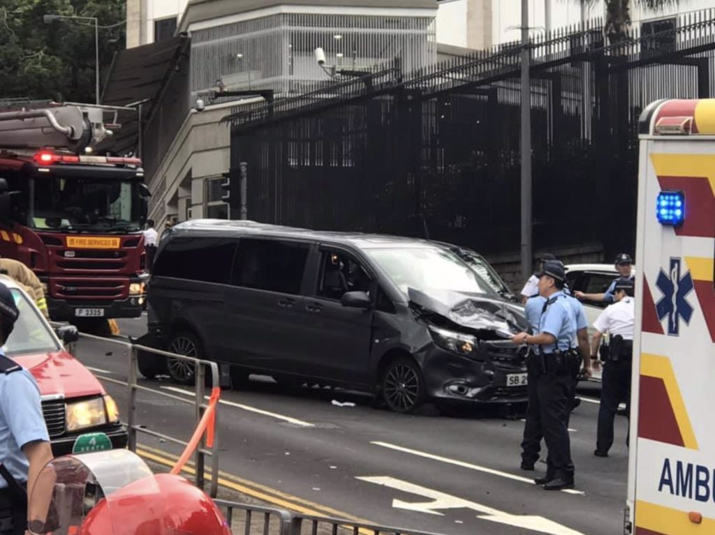 Police investigate the scene after a truck rammed into the back of a taxi -- bumping into a private car on the way -- on Garden Road this afternoon. Photo via Facebook/ ‎Ngo Wk.