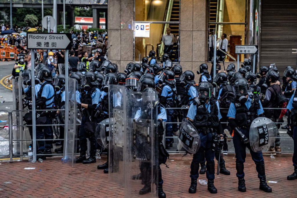 Police in riot gear during an extradition bill protest. Photo by Tomas Wiik.