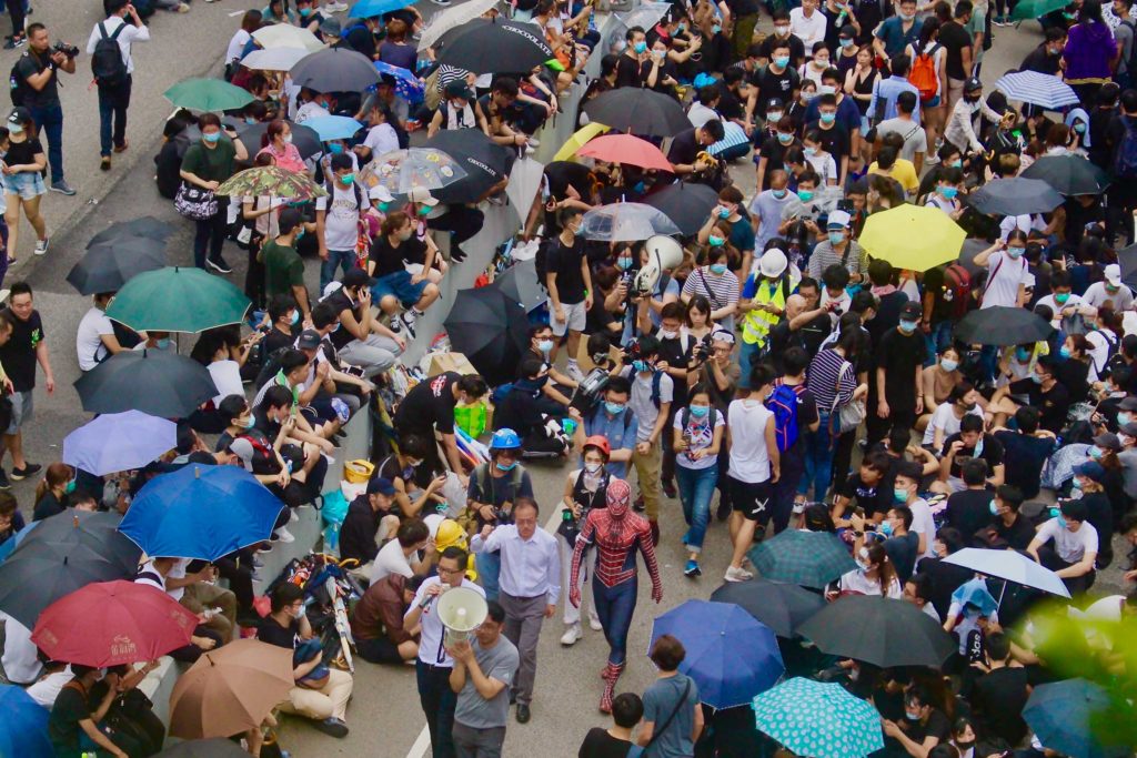 Pro-democracy lawmakers Lam Cheuk-ting and Fernando Cheung accompanied by Spiderman walking through the crowd during a protest against a controversial extradition bill. Photo by Vicky Wong.
