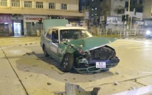 A black Porsche rammed into a green taxi while escaping from police during a high-speed chase in Yuen Long. Screengrab via Apple Daily video.