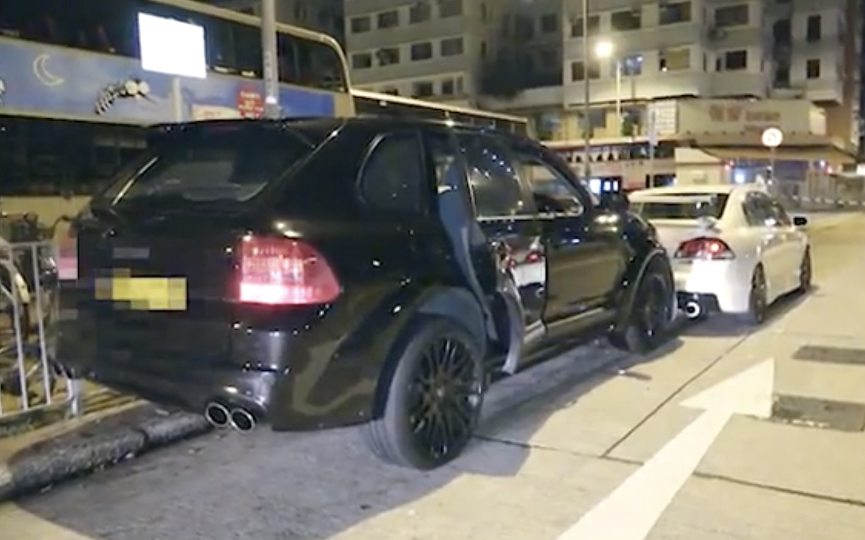 A black four-wheel drive Porsche crashes into the back of a stationary car after the driver led cops on a high-speed chase through Yuen Long. Screengrab via Apple Daily video.