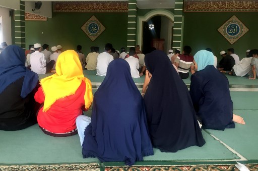 This picture taken on May 10, 2019 shows childen, whose parents were suicide bombers or those directly involved in terror plots, attending a religious function during the holy fashing month of Ramadan, in a mosque at a safe house in Jakarta. – Thrown off a motorbike as her parents blew themselves up, nine-year-old Mila — a name given by AFP to protect her identity — was the sole survivor of a family suicide bombing, part of a wave of such attacks involving children that rocked Indonesia. Orphaned and radicalised, there were concerns for her future after the Islamic State-inspired strike, but a renewed focus on rehabilitating the children of terror suspects may offer Mila, and others like her, a chance at normality. (Photo by Kiki Siregar / AFP)
