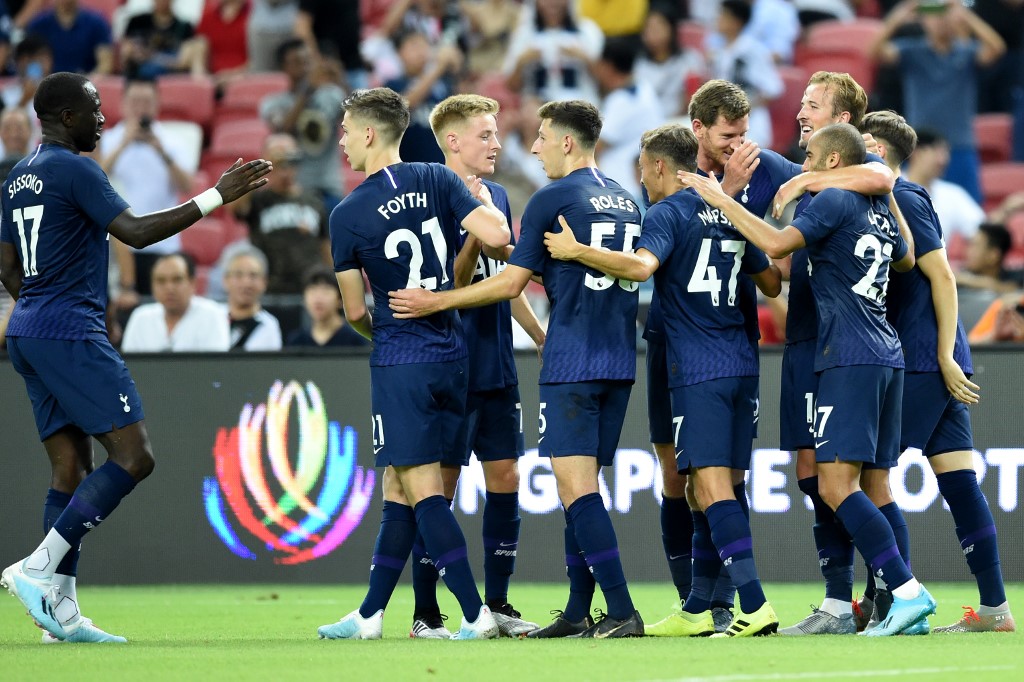 Tottenham Hotspur’s Harry Kane (R partially obscured) is congratulated by teammates after scoring during the International Champions Cup football match between Juventus and Tottenham Hotspur in Singapore on July 21, 2019. (Photo by Roslan RAHMAN / AFP)