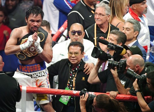 LAS VEGAS, NEVADA – JULY 20: Manny Pacquiao (L) and former Gov. of the province of Ilocos Sur, Philippines and the former Deputy National Security Adviser for the Philippine government Luis “Chavit” Singson (C) celebrate Pacquiao’s split-decision victory over Keith Thurman in their WBA welterweight title fight at MGM Grand Garden Arena on July 20, 2019 in Las Vegas, Nevada.   Ethan Miller/Getty Images/AFP