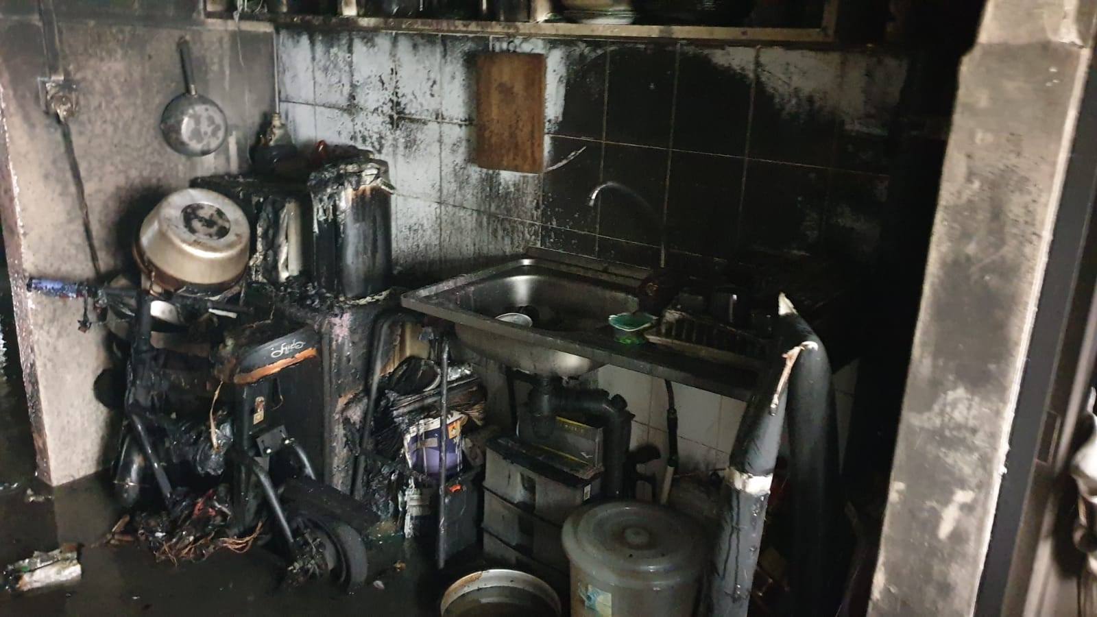 A personal mobility device placed in the kitchen of an Ang Mo Kio flat that had been razed by a fire. (Photo: Facebook/SCDF)