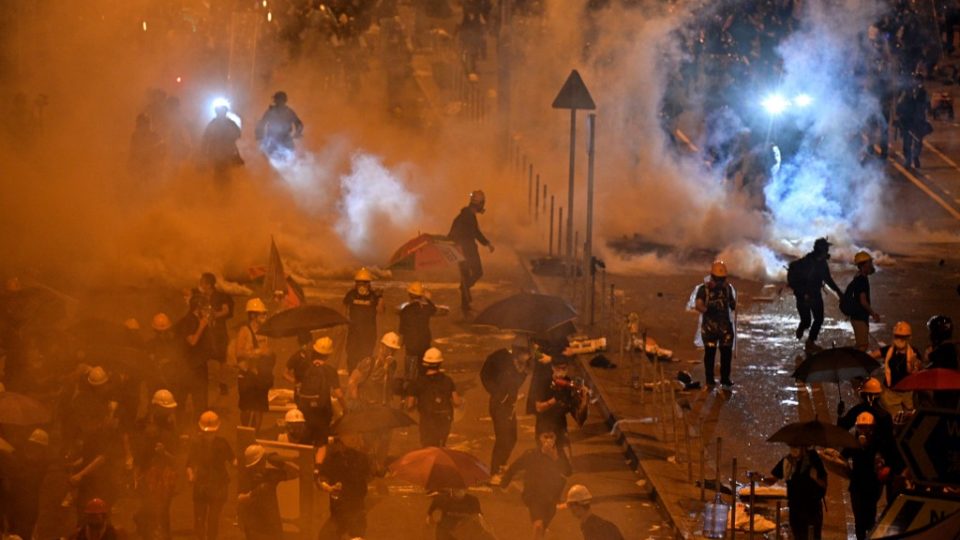 Police fire tear gas at protesters near the government headquarters in Hong Kong in the early hours of Tuesday. Photo via AFP.