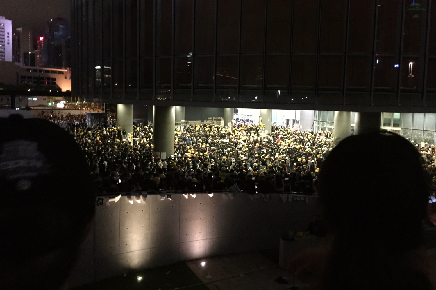 A crowd of protesters waits outside of the Legislative Council on July 1 after demonstrators forced their way into the building. Photo by Stuart White.