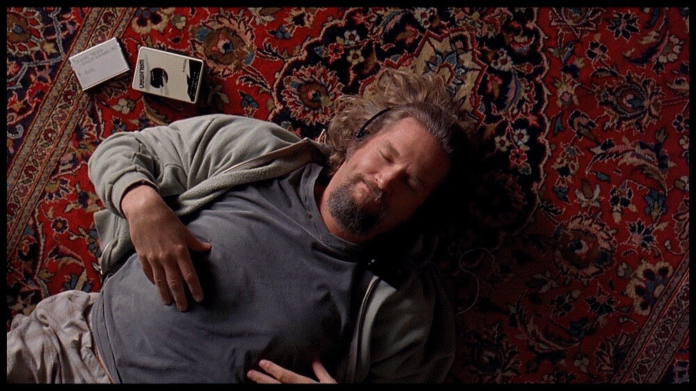 Jeffrey “The Dude” Lebowski lays down on a rug that “really tied the room together” in <i></noscript>The Big Lebowski</i>. Image courtesy of Working Title Films.