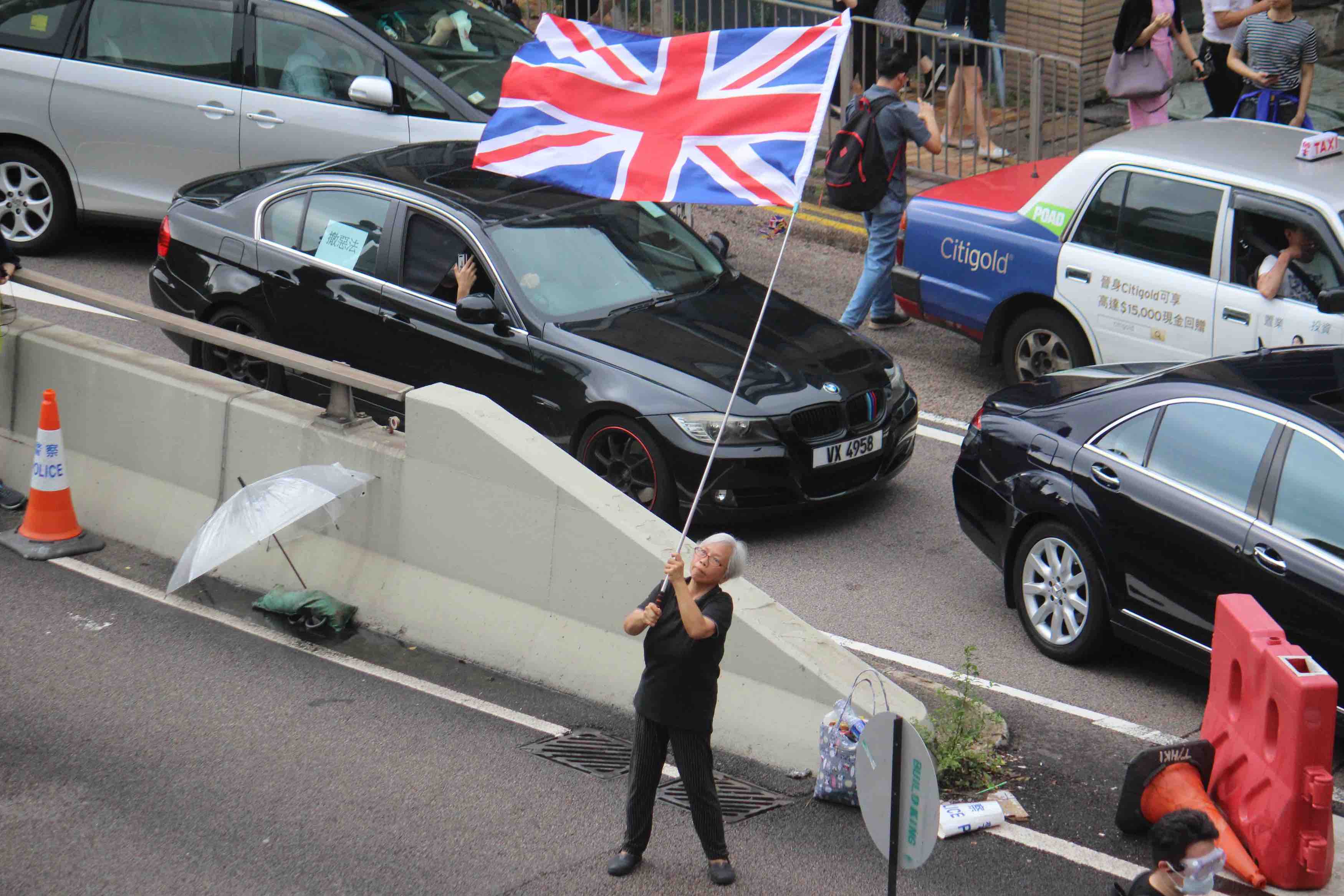 Alexandra Wong waves the British flag at a demonstration in Hong Kong on June 12. Photo by Vicky Wong.