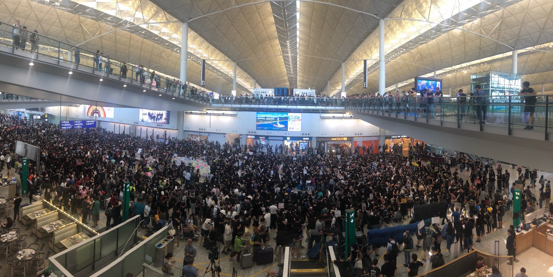 A crowd of pro-democracy protesters gathered at Hong Kong International Airport today to spread their message to international arrivals to the city. Photo by Iris To.