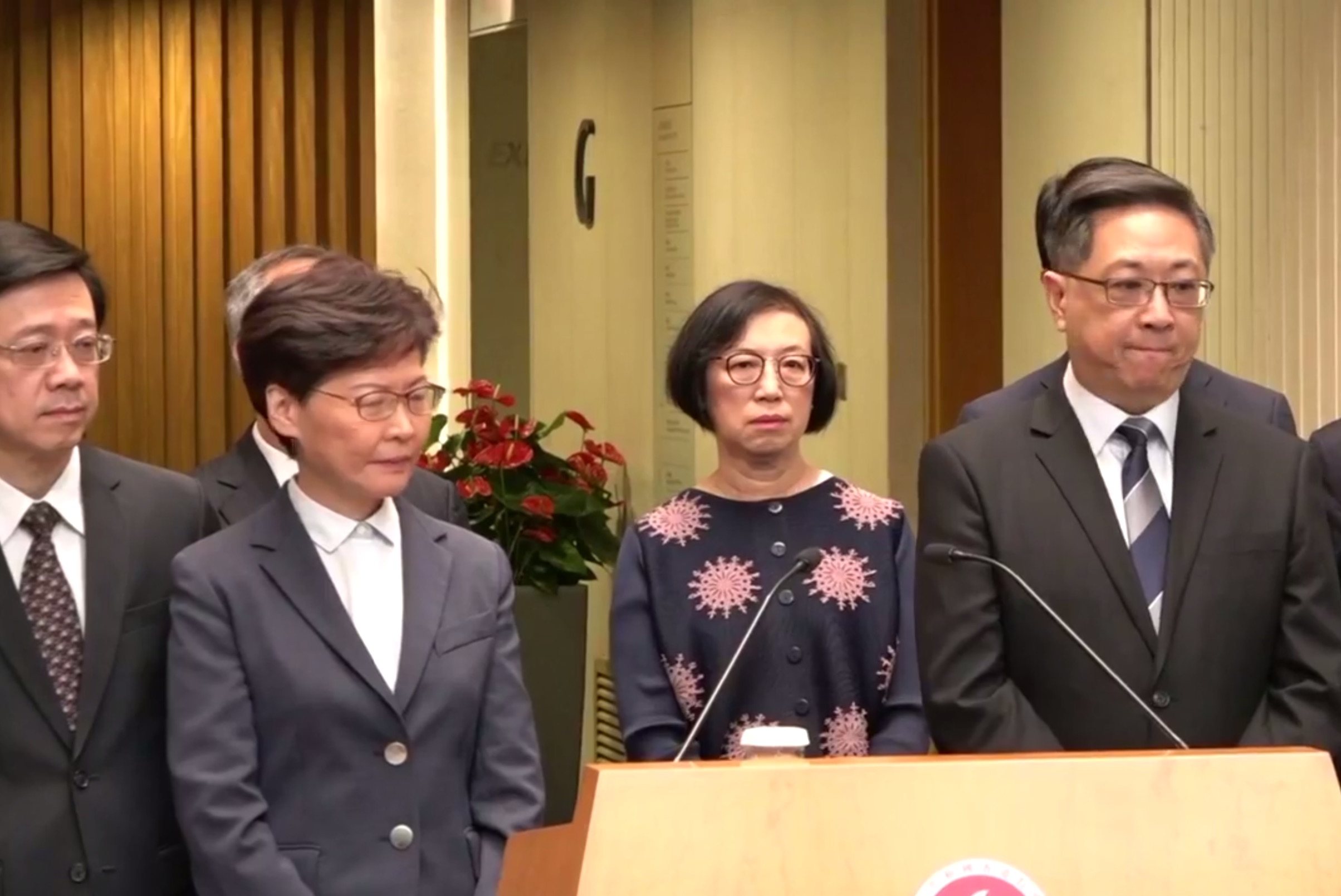 Security Secretary John Lee (left), Chief Executive Carrie Lam (second left), and Police Commissioner Stephen Lo (far right) face the press this afternoon. Screengrab via RTHK video.