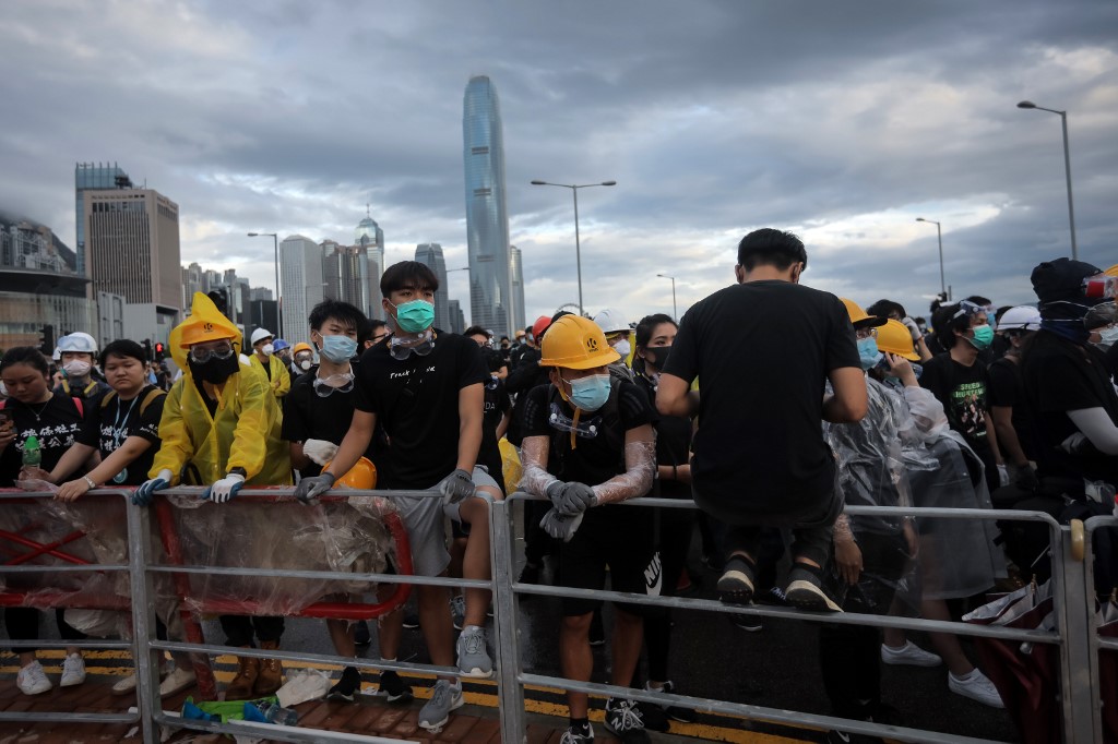 Protesters set up barricades at Lung Wo Road outside the Legislative Council in Hong Kong before the flag raising ceremony to mark the 22nd anniversary of handover to China early this morning. Photo via AFP.