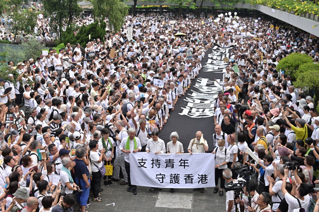 A group of elderly people march to the government headquarters in Hong Kong yesterday in solidarity with the city’s young anti-government protesters. Photo via AFP