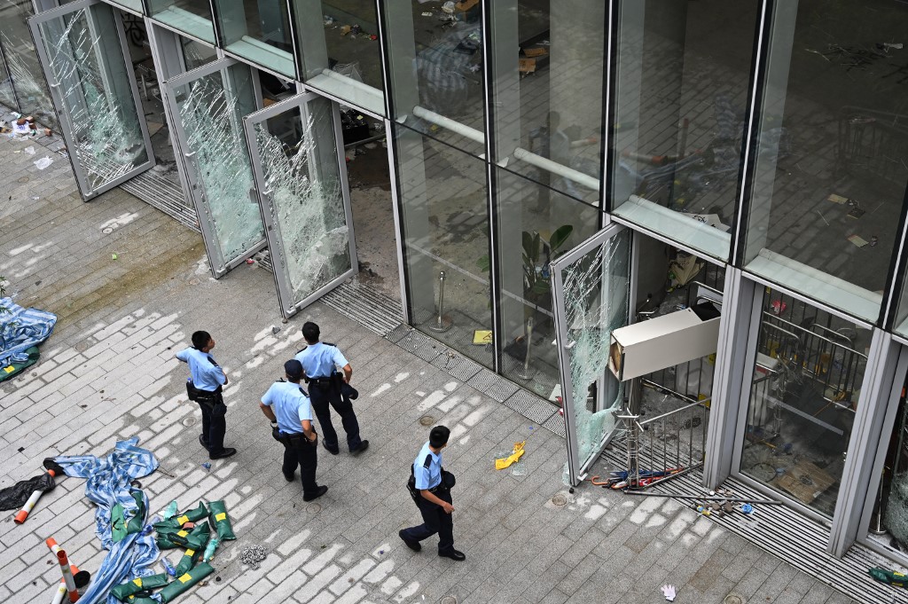 Police stand outside the Legislative Council building in Hong Kong on July 2, a day after protesters broke into the building. Photo via AFP.
