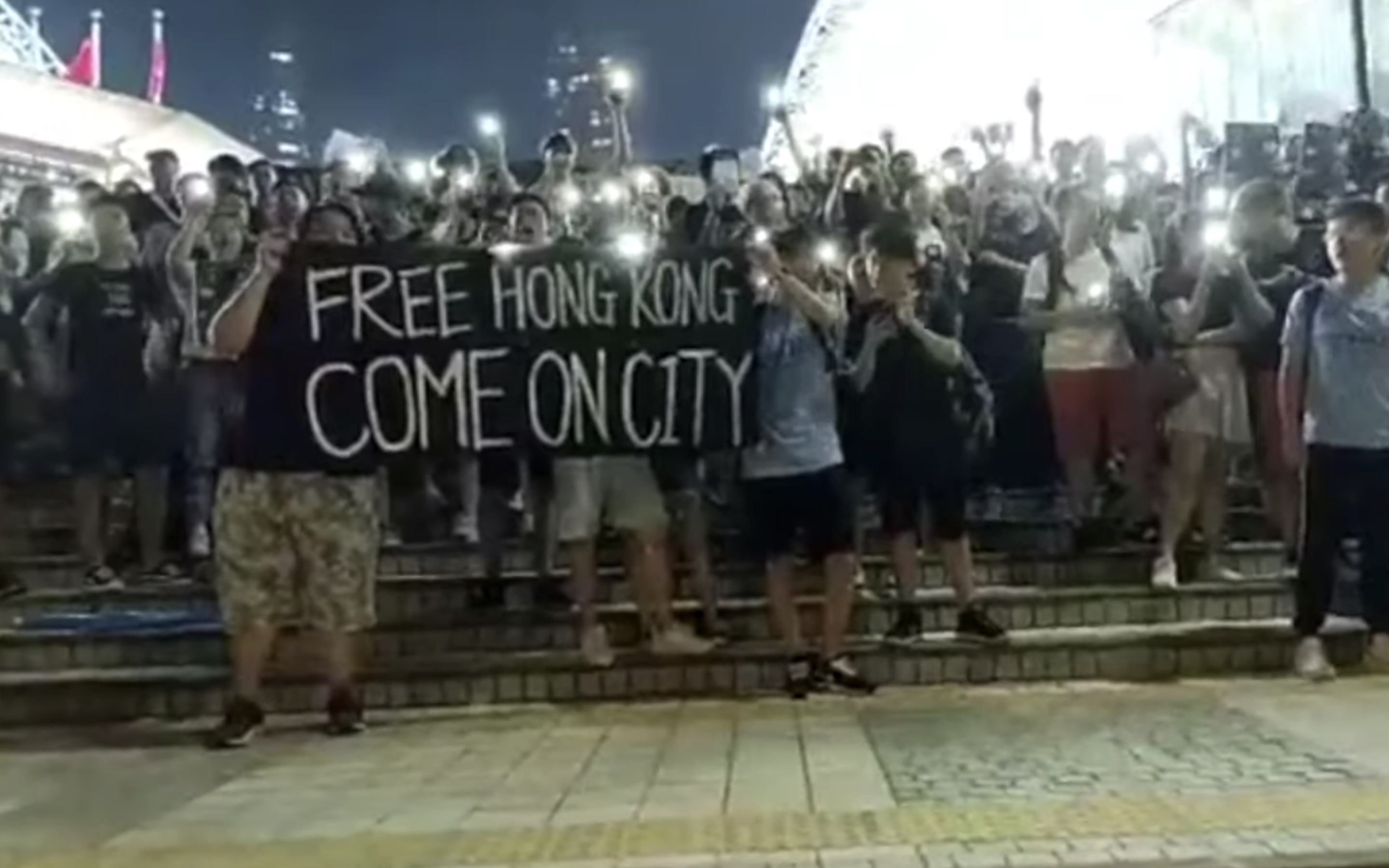 Hongkongers gather outside Hong Kong stadium after a friendly match between Manchester City and local club Kitchee. Screengrab via YouTube.