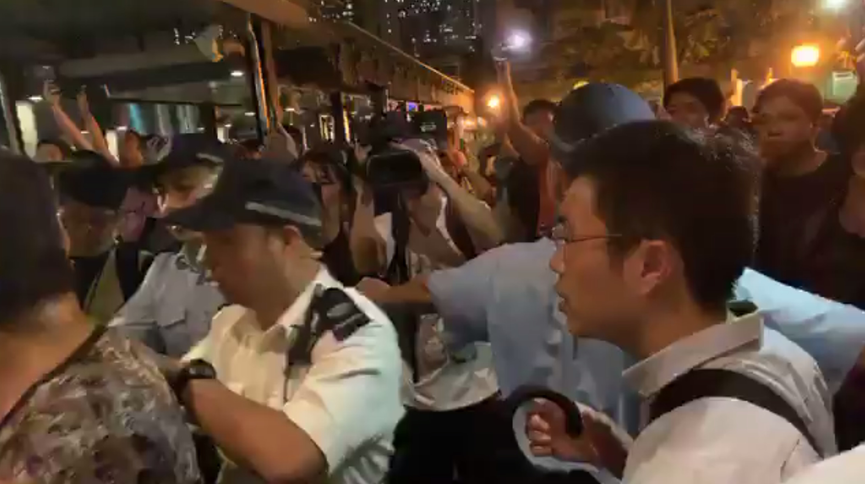 Police attempt to calm a crowd of both supporters and opponents of the city’s ongoing protest movement at a “Lennon Wall” in Yau Tong on July 10. Screengrab via Facebook.
