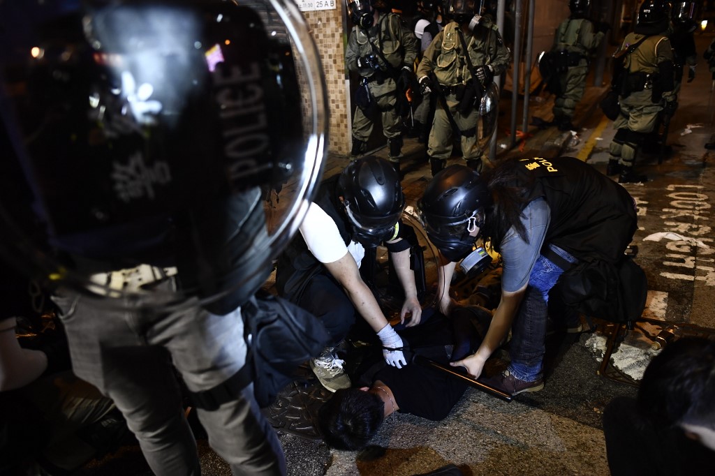 Police officers arrest a protester taking part in a demonstration against what activists say is police violence in Hong Kong on July 28, 2019. Anthony Wallace / AFP)