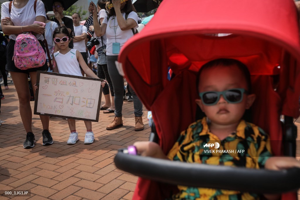 A girl holds a sign during a “guard our children’s future” event for families who are against a controversial extradition bill in Hong Kong on August 10, 2019. – Armed with balloons and strollers, several hundred families took to the streets in Hong Kong on August 10 to show support for pro-democracy protests that are now in their third month. (Photo by VIVEK PRAKASH / AFP)