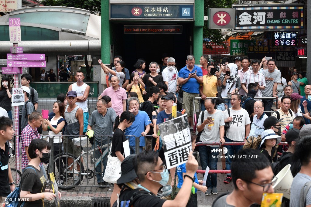Protesters march against a controversial extradition bill in the Sham Shui Po area of Hong Kong on August 11, 2019. (Photo by Anthony WALLACE / AFP)