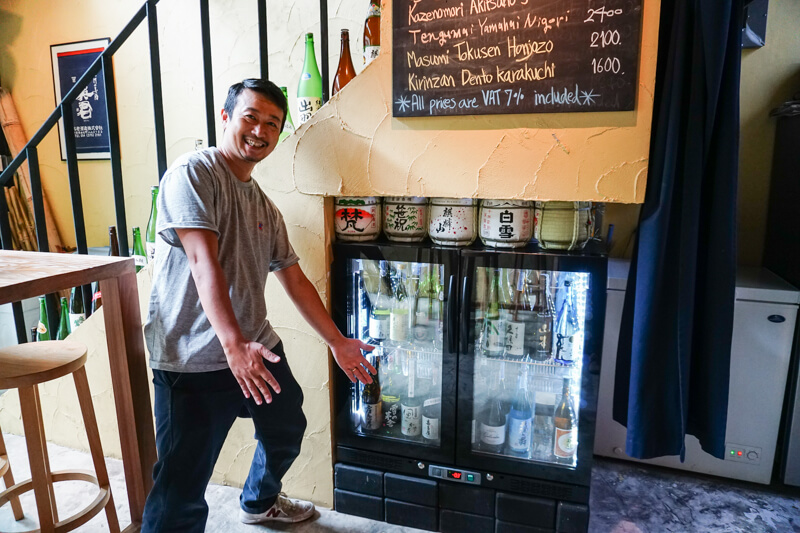 Yoshito Suzuki shows some love for his sake fridge. Photo: Coconuts Media 