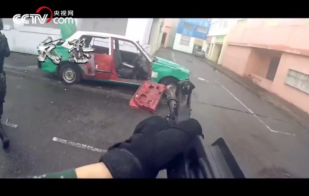 A still from a PLA video showing an urban combat scenario featuring a Hong Kong taxi. Screengrab via YouTube.