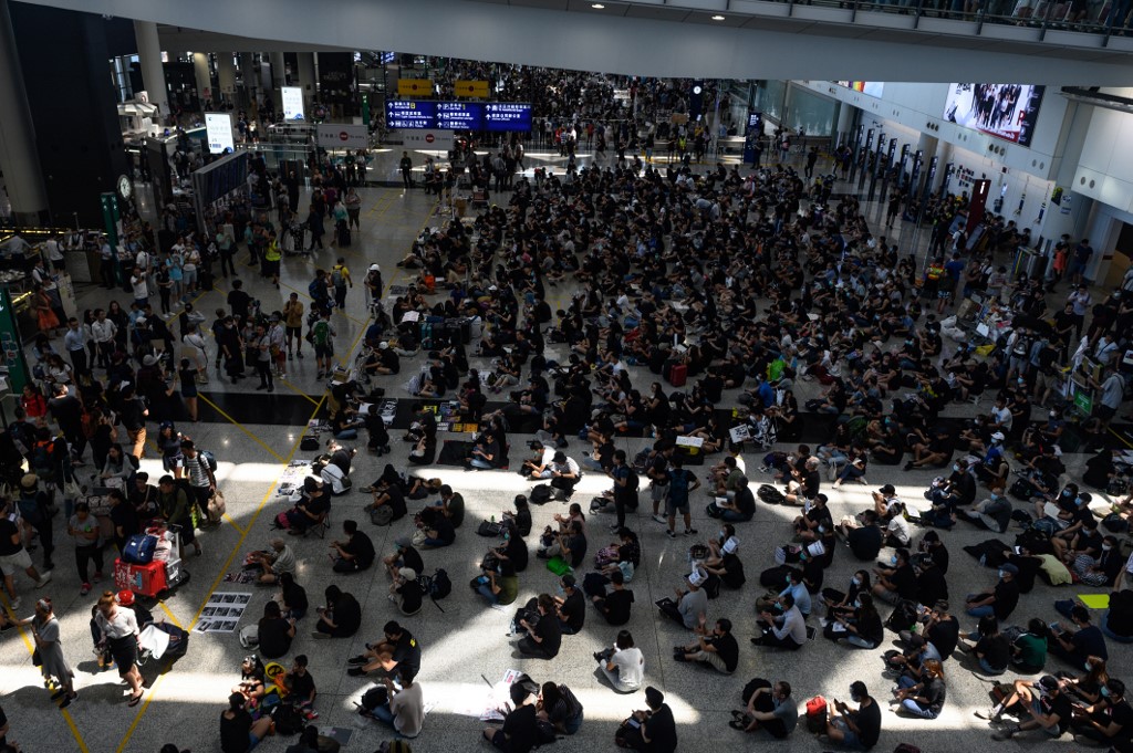 Protesters take part in a rally at Hong Kong International Airport today. Photo via AFP.