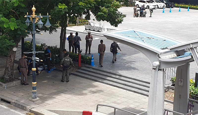 Police and forensics personnel investigate the scene of a bombing at BTS Chong Nonsi on Friday morning in Bangkok. Photo: Coconuts