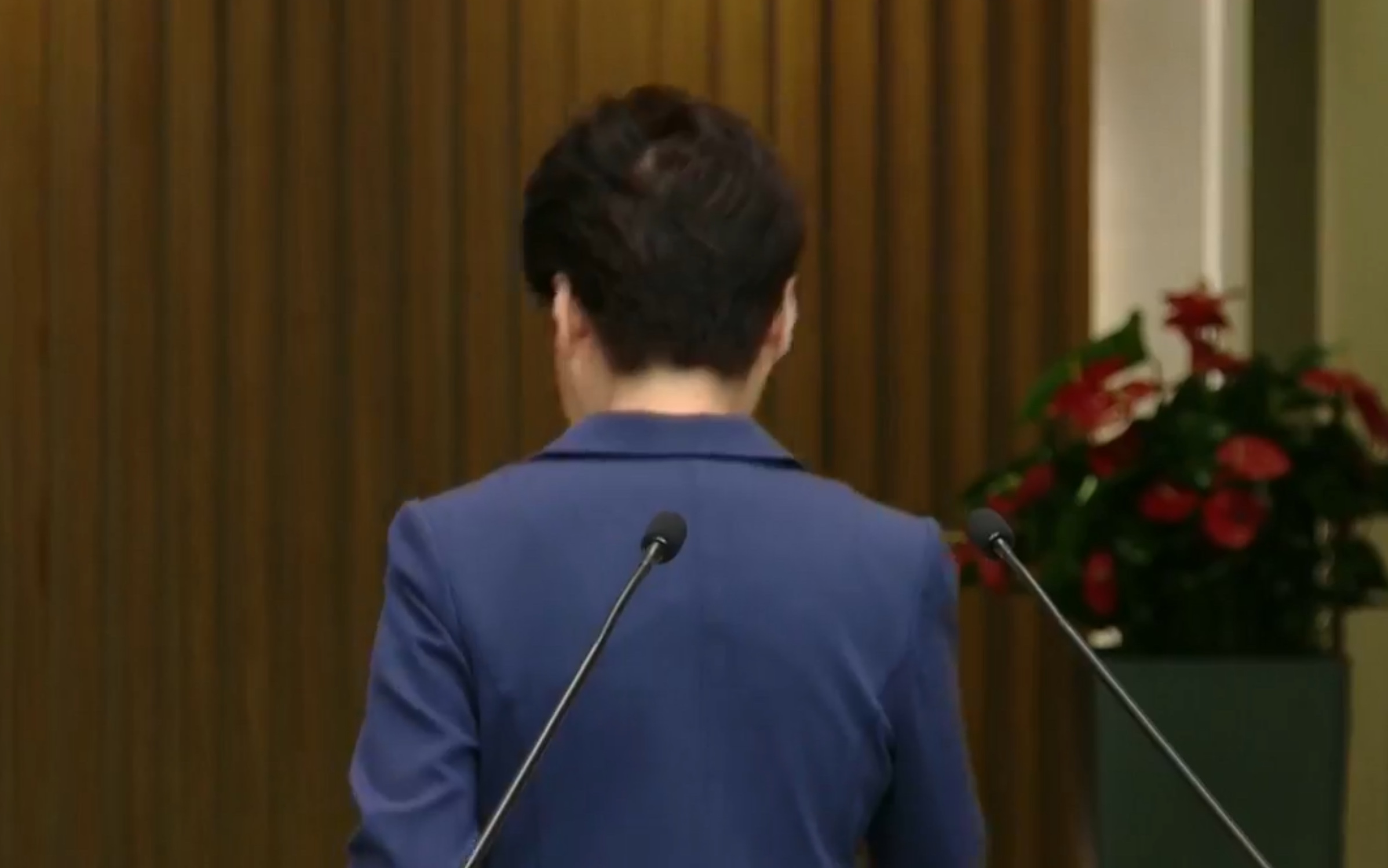 Hong Kong Chief Executive Carrie Lam leaves a heated press conference in August. Screengrab via RTHK livestream.