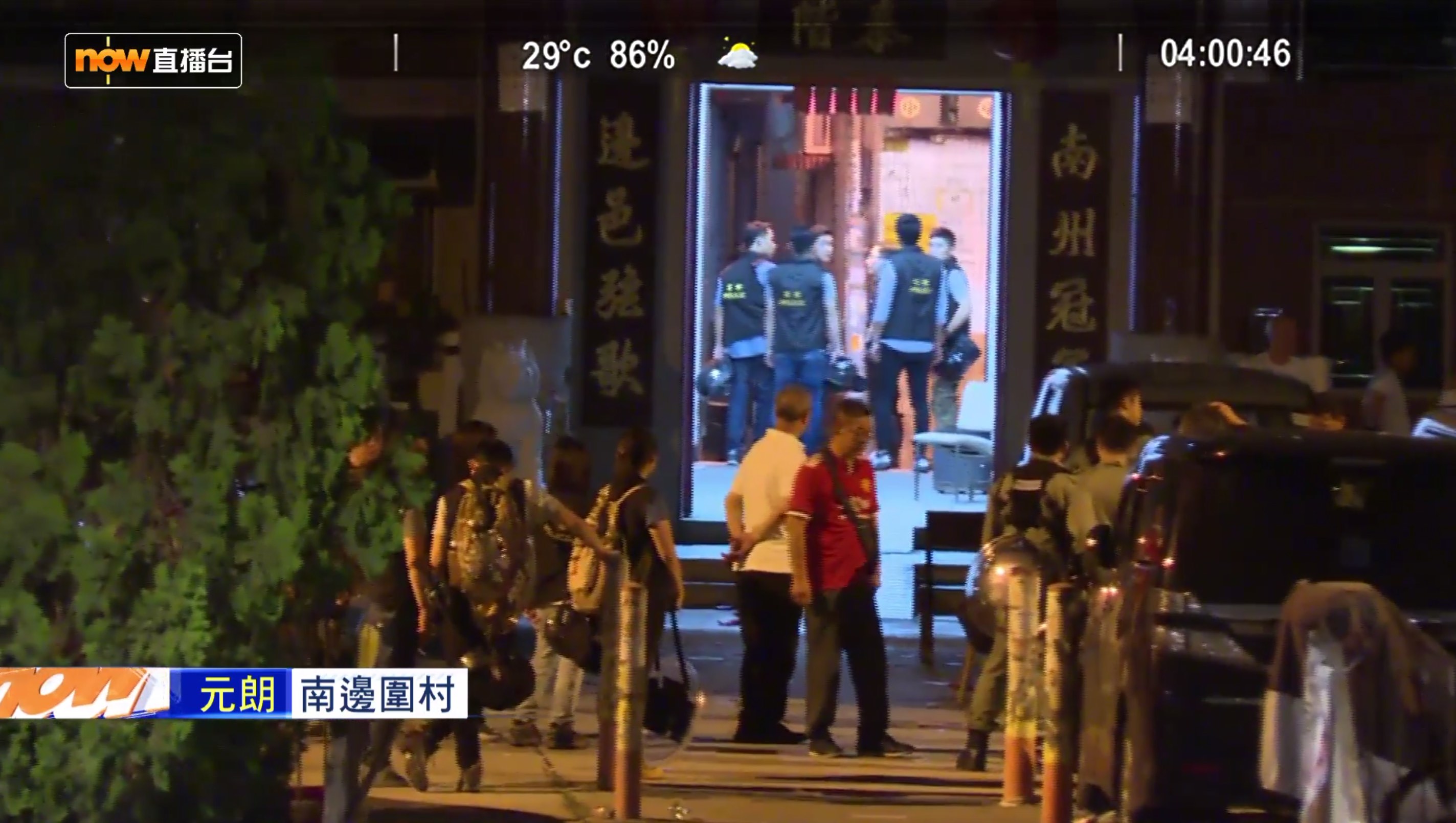 Police are seen chatting with white-shirted men inside a village office in the aftermath of the Yuen Long attacks in a livestream from the scene by Now TV. Screengrab via Facebook.