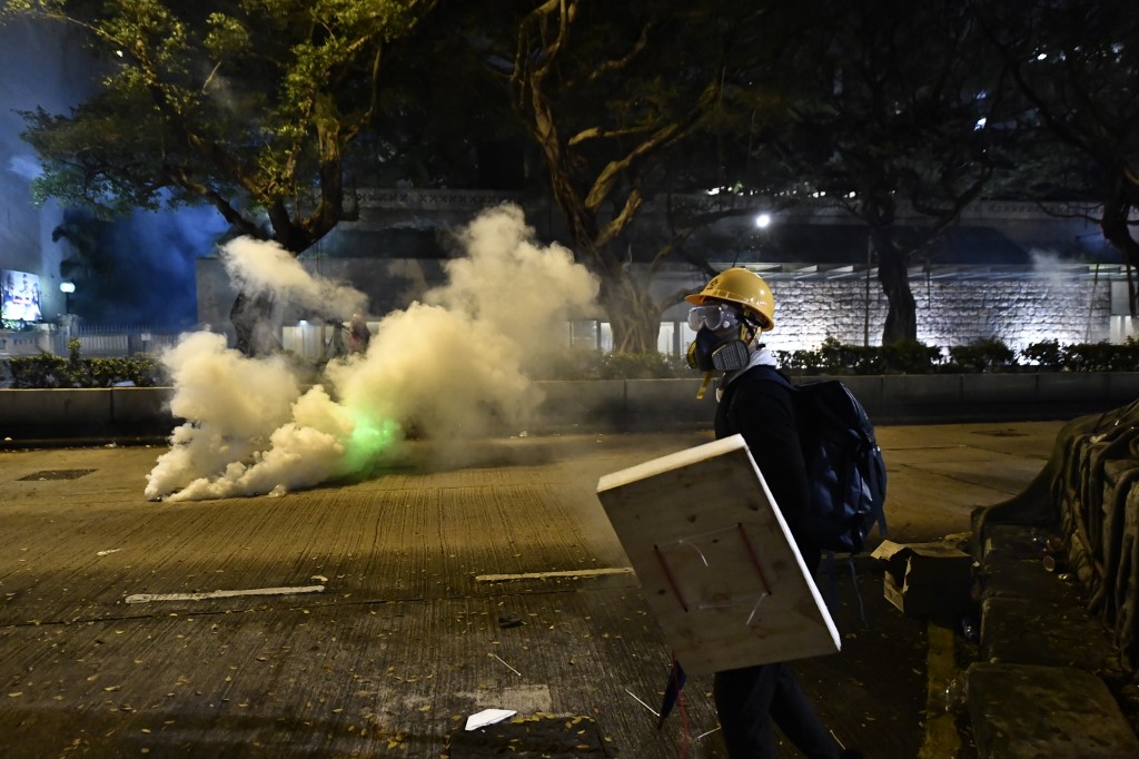 A protester holds a makeshift shields along a road outside the Tsim Sha Tsui police station on August 3. Photo via AFP.