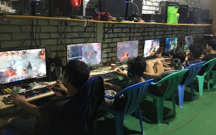 Yangon gamers ply their trade at a local internet café. A recent spate of blackouts have seen many competitive gamers switch to their phones for fear of losing power during game play.