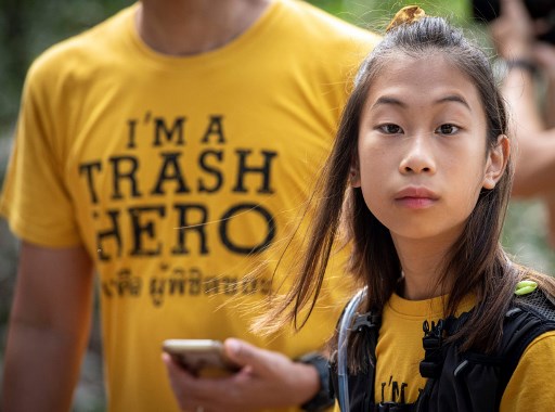 In this picture taken on August 25, 2019, 12-year-old Ralyn Satidtanasarn, known by her nickname Lilly, takes part in the Trash Hero cleaning initiative at the Khung Bang Kachao urban forest and beach in Bangkok. Photo: Mladen Antonov / AFP