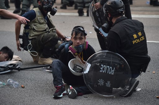 A man (C) is detained by police during clashes following an unsanctioned march through Hong Kong on September 29, 2019. Photo: Nicolas ASFOURI for AFP