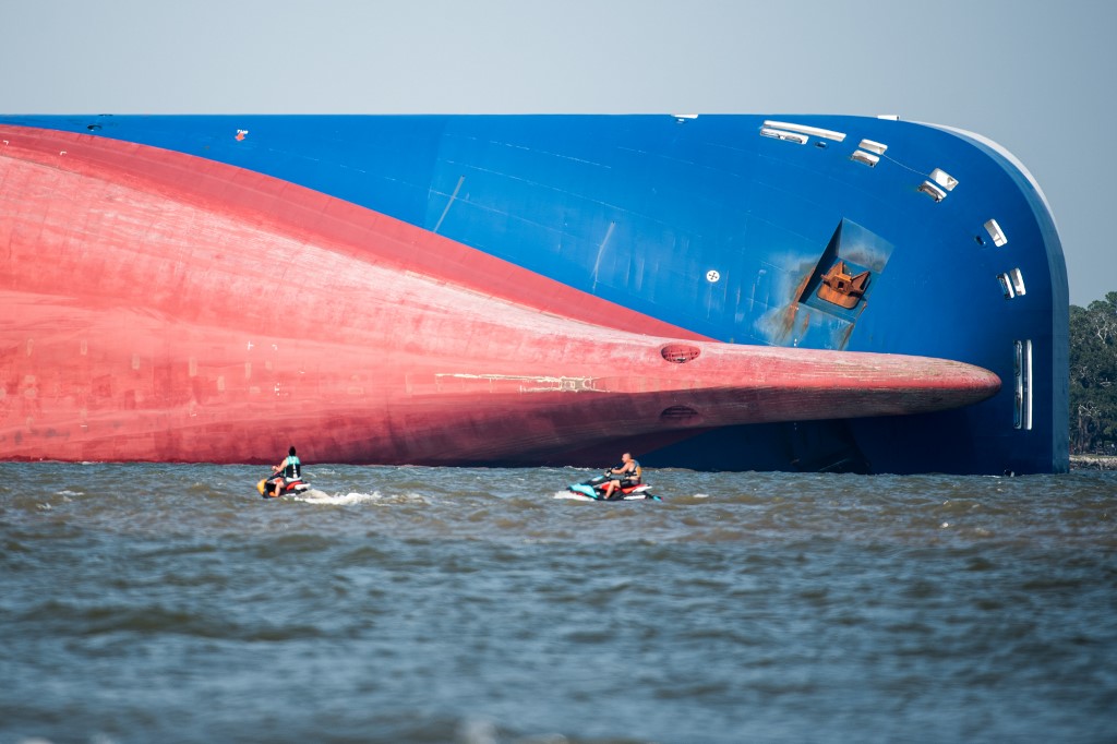 Emergency responders work to rescue crew members from a capsized cargo ship on September 9, 2019 in St Simons Island, Georgia. A 656-foot vehicle carrier, the M/V Golden Ray departed the Brunswick port on Sunday and suffered a fire on board, capsizing in St. Simons Sound. <i></noscript>Photo: Sean Rayford/Getty Images/AFP</i>