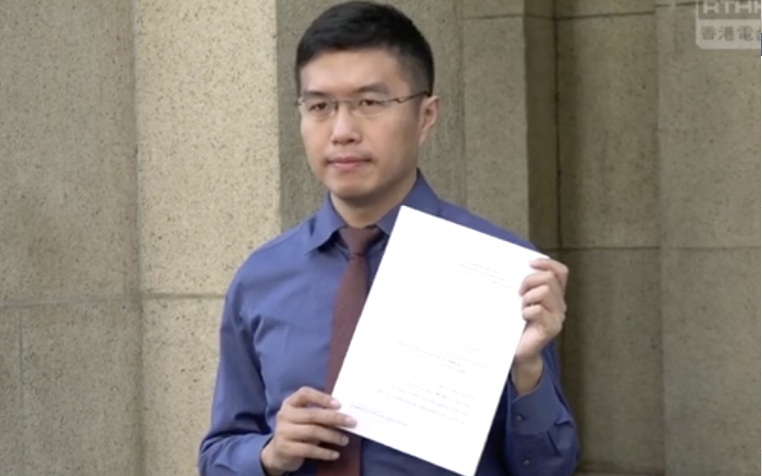 Au Nok-hin stands outside the Court of Final Appeal as he announces he will be appealing a High Court decision that ruled that the authorities were wrong to bar Agnes Chow from running in a by-election he eventually won. Screengrab  via Facebook video.