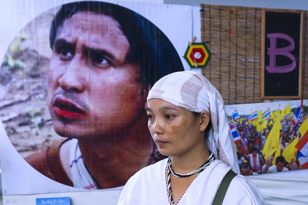 Pinnapha Phrueksapan, widow of ethnic Karen leader Por Cha Lee Rakcharoen — known as Billy, stands beside the portrait of her late husband following a ceremony in Bangkok on September 16, 2019. The wife of a murdered activist whose charred remains were found dumped in a Thai reservoir led an emotional memorial on September 16, saying their five young children had been left bereft by his death.
Photo: Joe Freeman / AFP