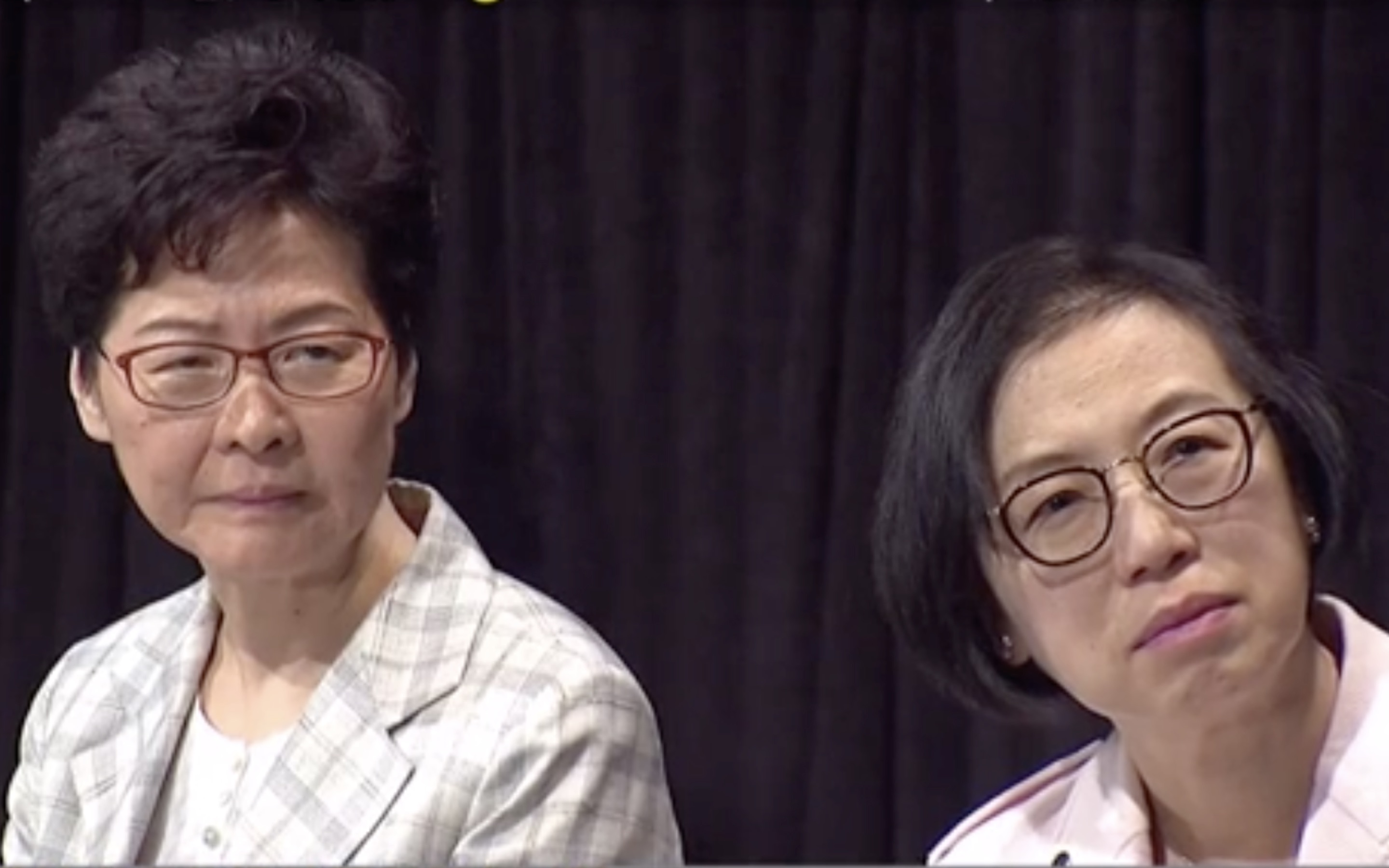 Chief Executive Carrie Lam and Health Secretary Sophia Chan listen to a question from a member of the public at a town hall meeting in Wan Chai on Thursday night. Screengrab via Facebook/Now News.