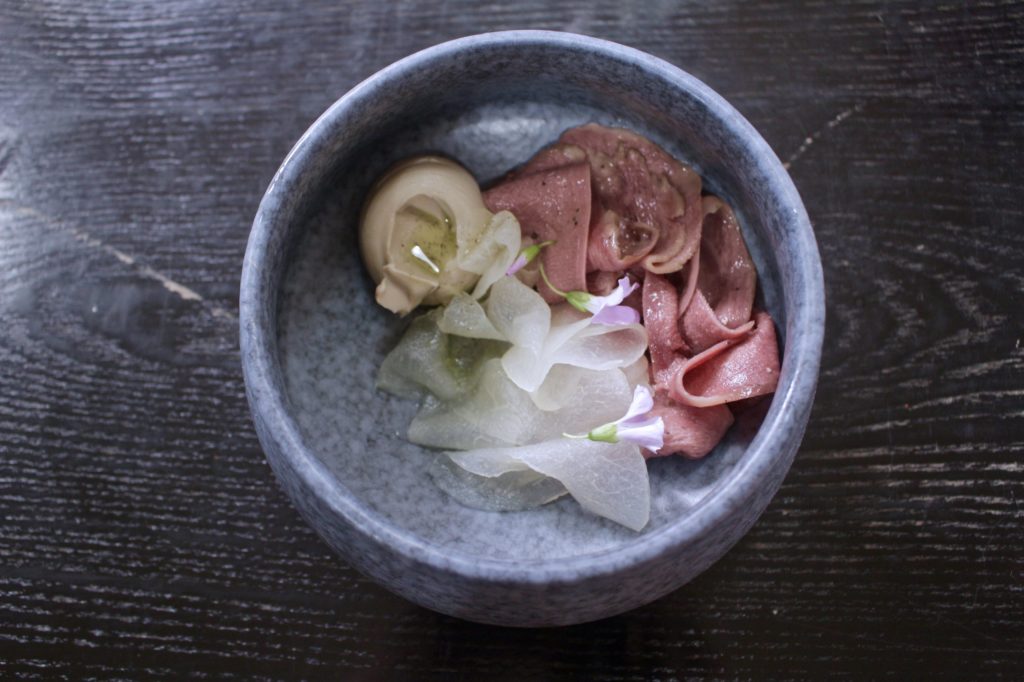 wagyu tongue with smoked mackerel and pickled nashi pear made with edible flowers and Kyoho grapes. Photo by Vicky Wong.